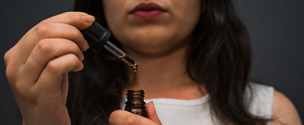 Woman measures cannabis tincture