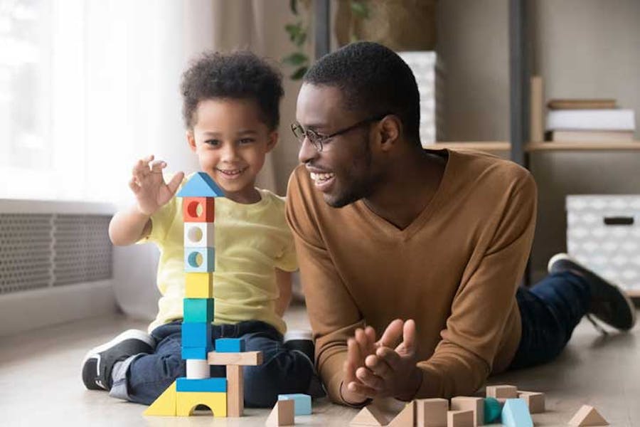 father plays blocks with his small son