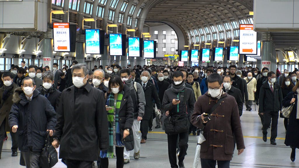 Crowds of people walking at Shinagawa station in busy morning rush hour, Tokyo, Japan. 