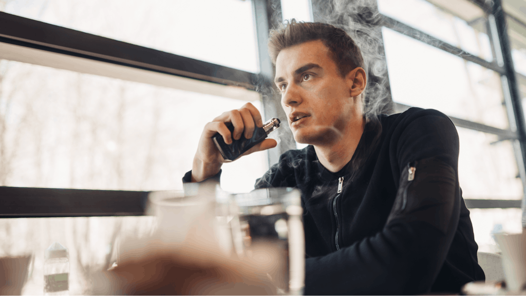 Man vaping in closed public space
