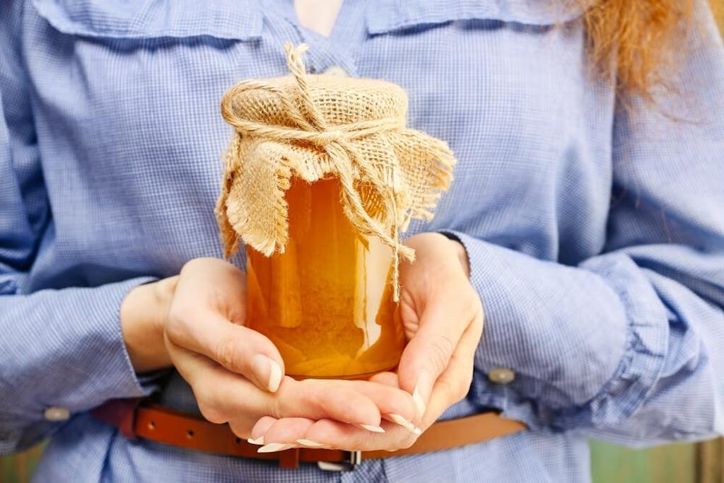 Holding a jar of cannabis-infused honey