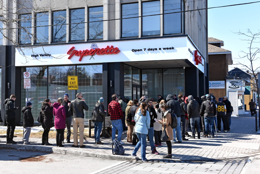 Customers wait in line to enter the marijuana dispensary on the first day for legal retail store sale of cannabis in Ontario