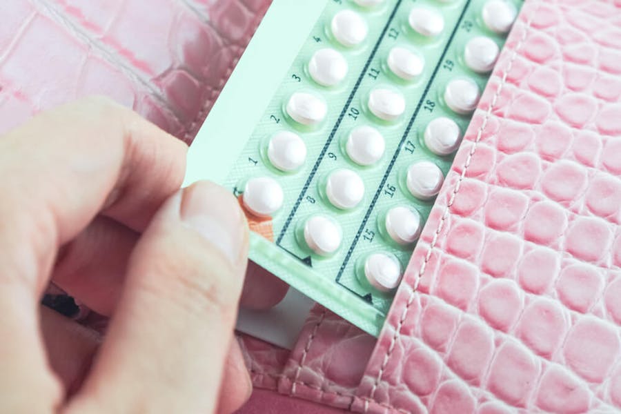 Birth control pills in a woman's wallet