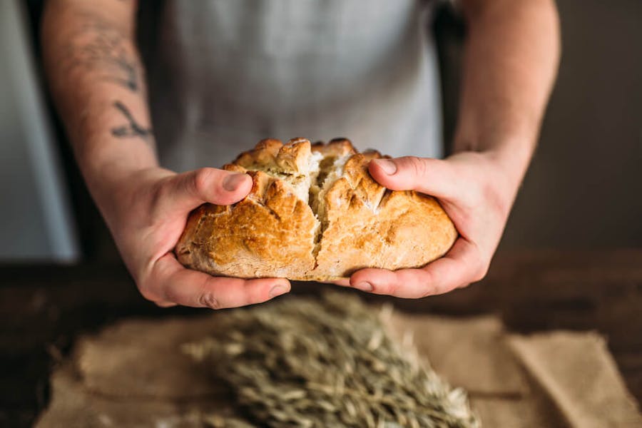 Breaking open a loaf of freshly baked cannabis bread
