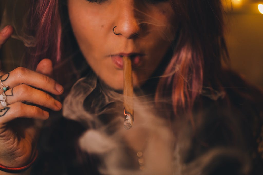 Close-up shot of a woman smoking a blunt