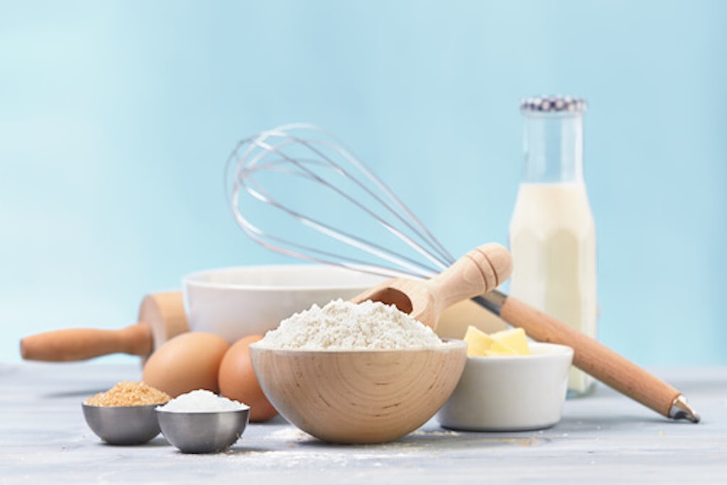 Ingredients and tools to make a sugar cookies, including flour, butter, sugar,eggs