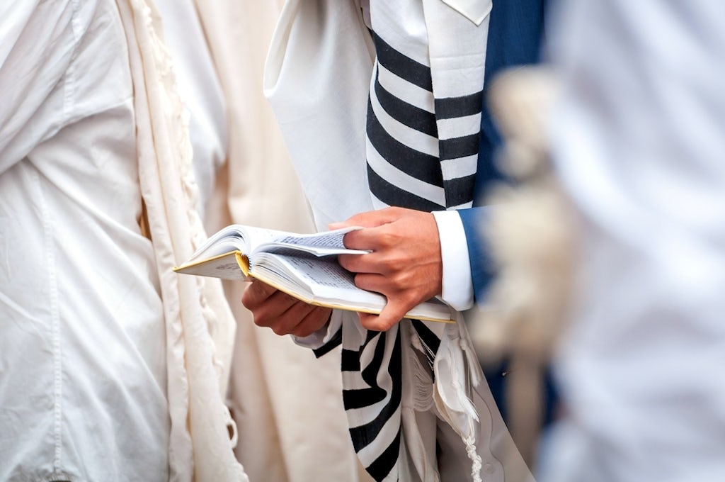 Orthodox hassidic Jews pray in a holiday robe and tallith